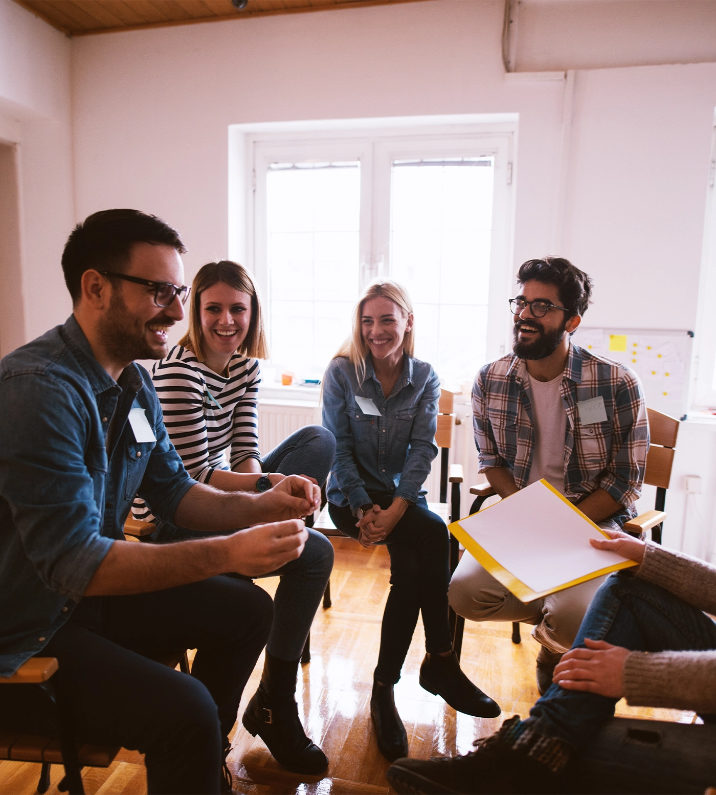 Group of people in group therapy feeling positive.