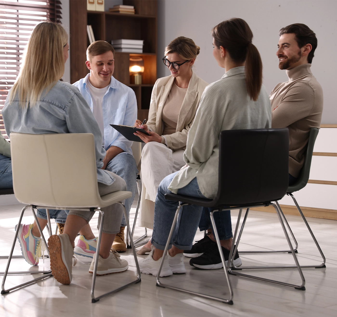 Group of people having psychotherapy session indoors