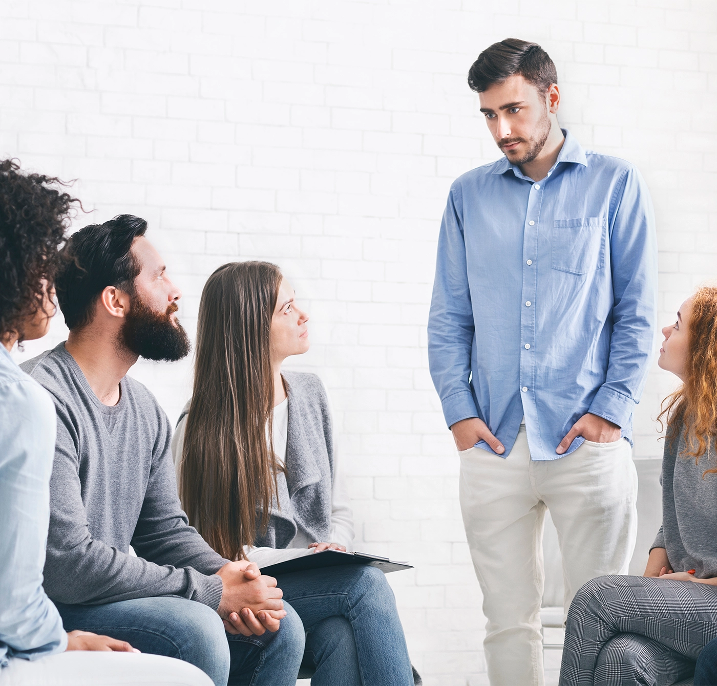 young man talking about his problems during group therapy
