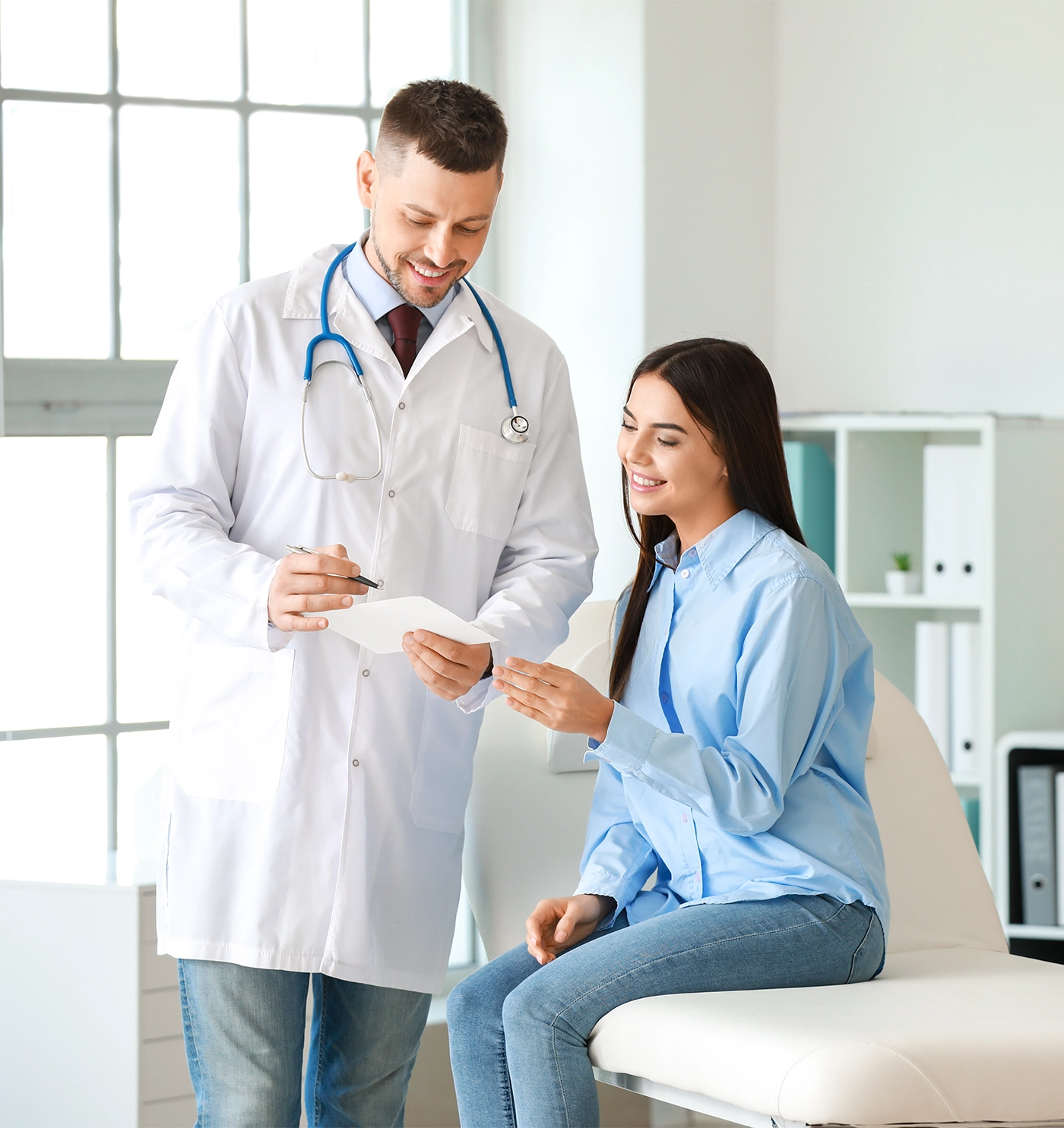 Male doctor working with woman in clinic