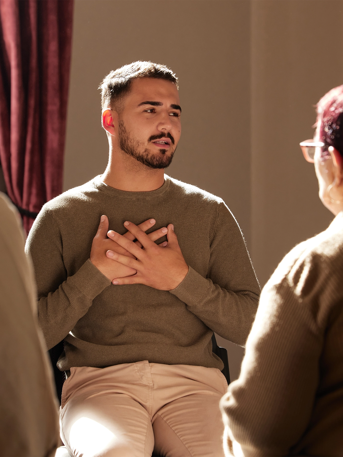 Support, trust and man sharing in group therapy with understanding, feelings and talking in session. Mental health, addiction or depression, men and women with therapist sitting together for healing.
