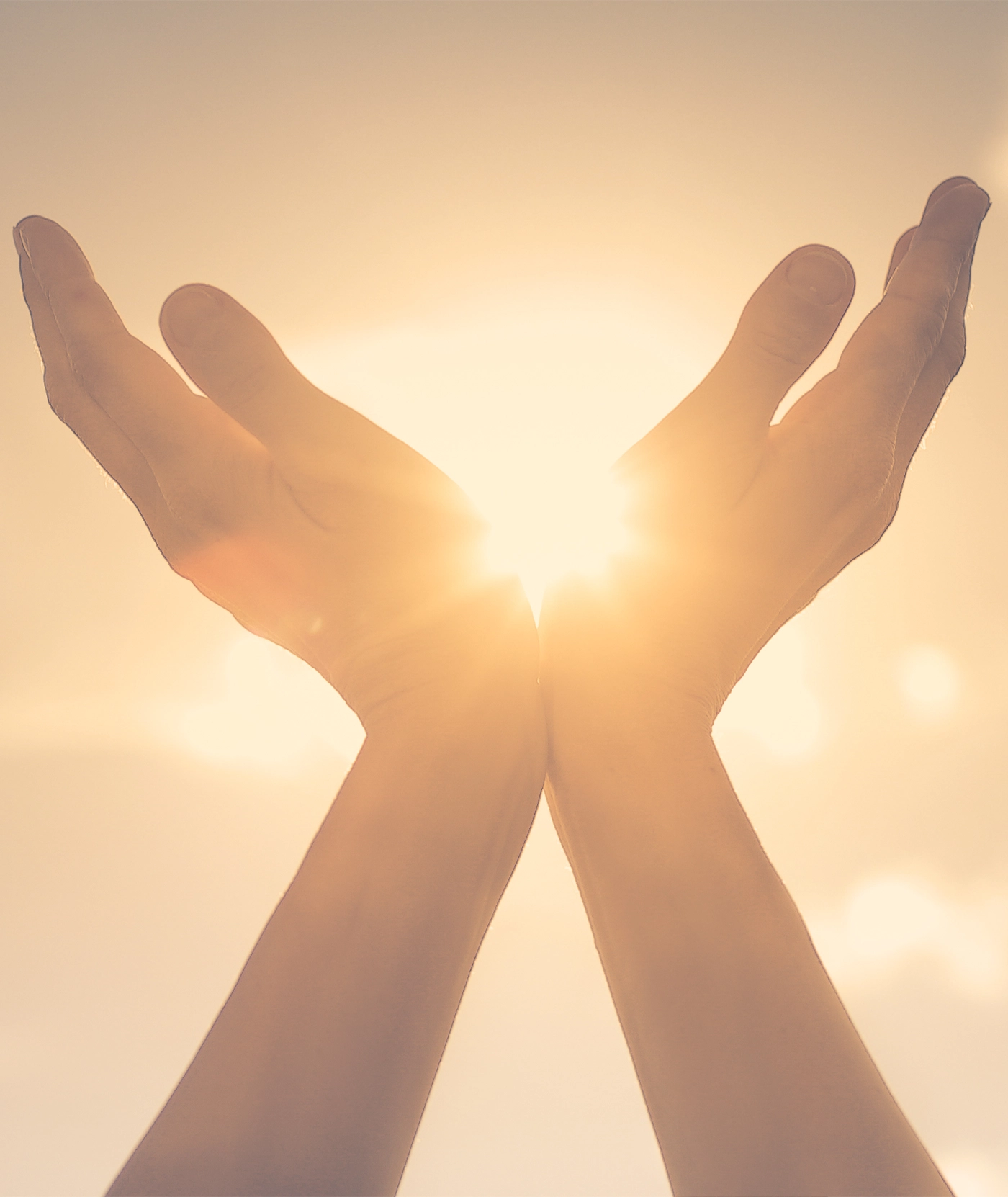Persons hand holding sun in palm feeling energized. Spiritual, mind, body concept.