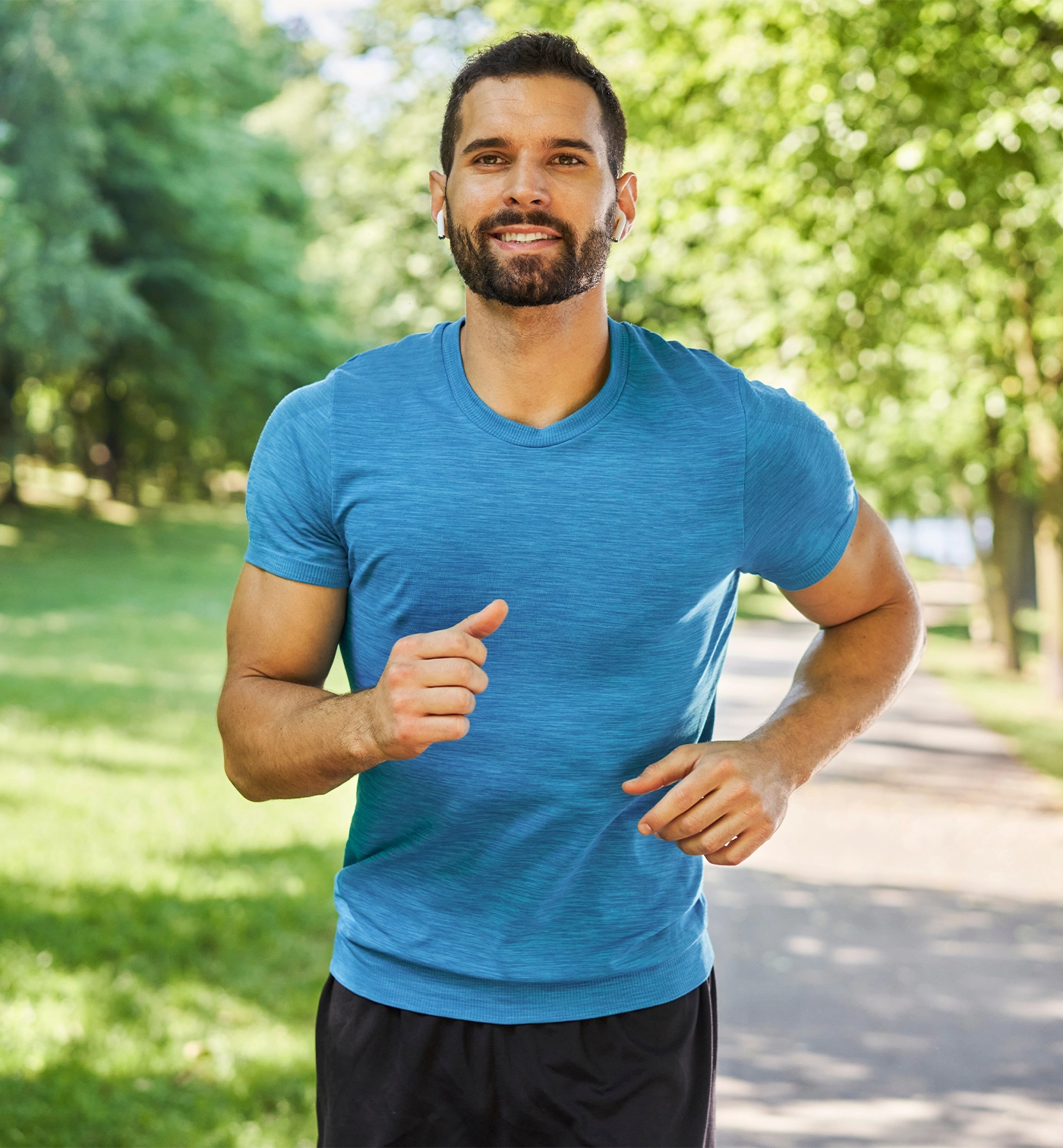 Smiling man running in park