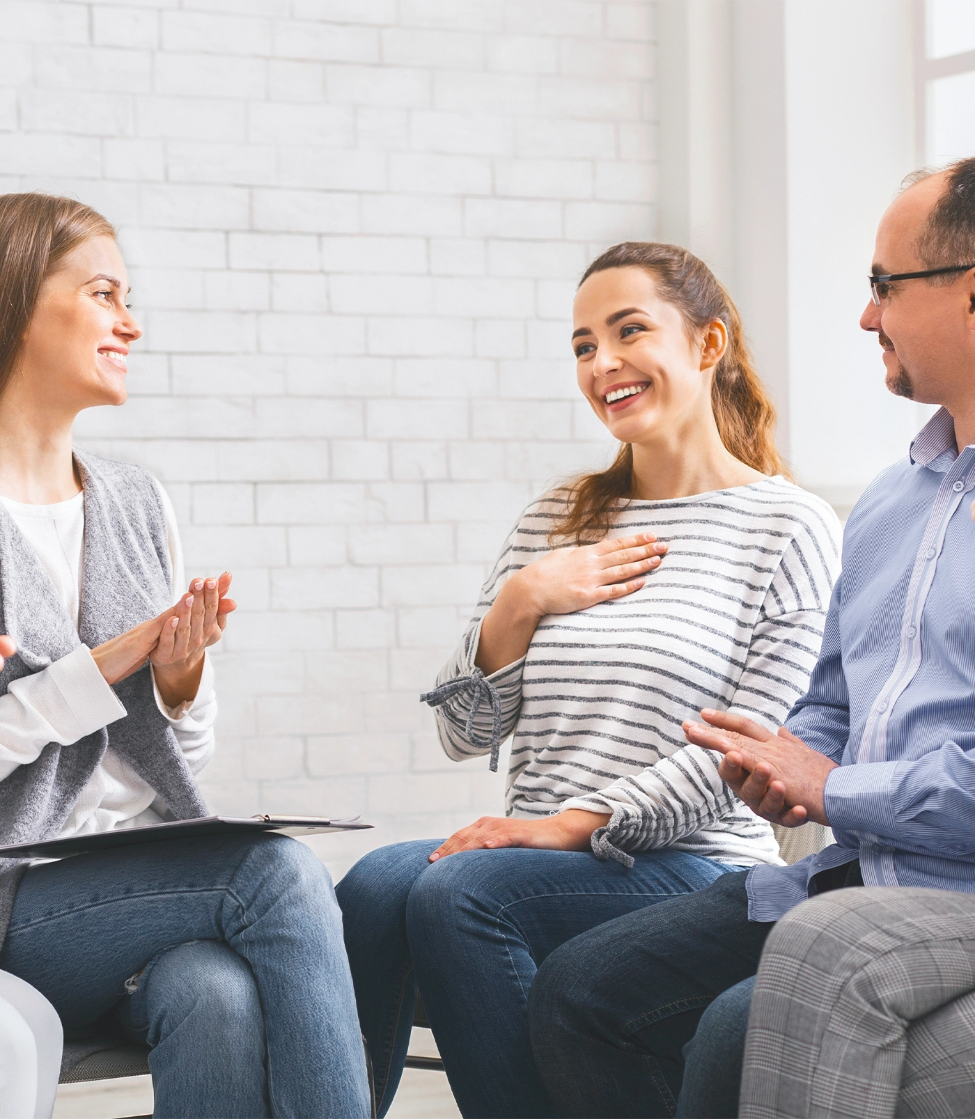 woman sharing her progress with group in rehab
