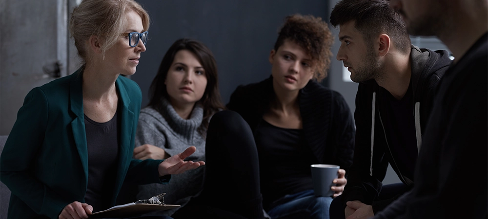 Therapist talking with patients of rehab centre