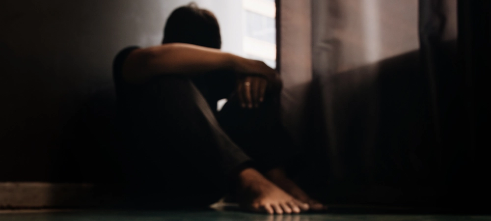 Conceptual image on the subject of drug addiction.man sitting and hugs his knees. depression self destruction suicidal addicts drug