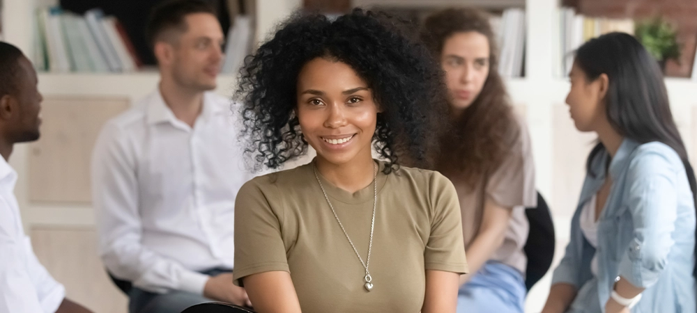 African american female psychologist psychotherapist looking at camera during group therapy session, black woman coach counselor therapist posing during team training with diverse people, portrait