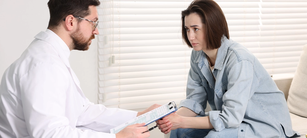 Alcoholic woman having appointment with healthcare specialist in clinic. Addiction treatment