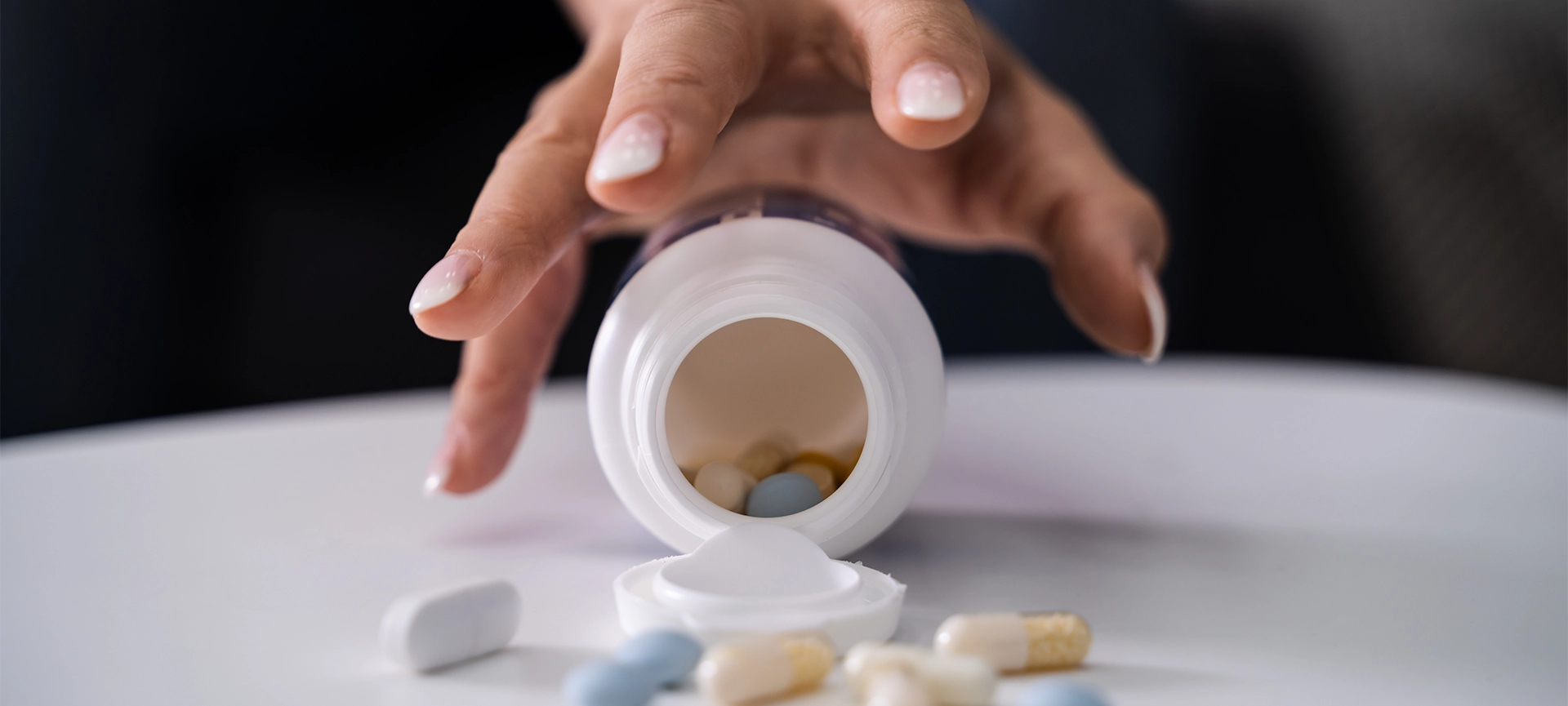 Drug Addicted Woman Reaching For Medication At Home