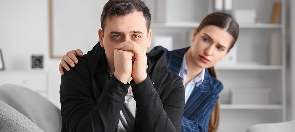 Male drug addict with psychologist sitting in office