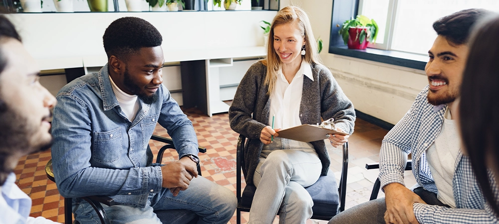 Young people sitting in a circle and having a discussion