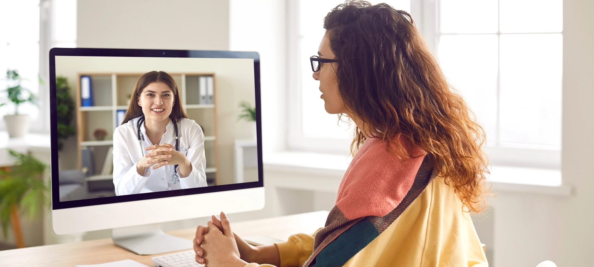 Sick woman listening recommendations and appointment having online video call with a female friendly smiling doctor using pc computer at home. Telemedicine and patient consultation online concept.