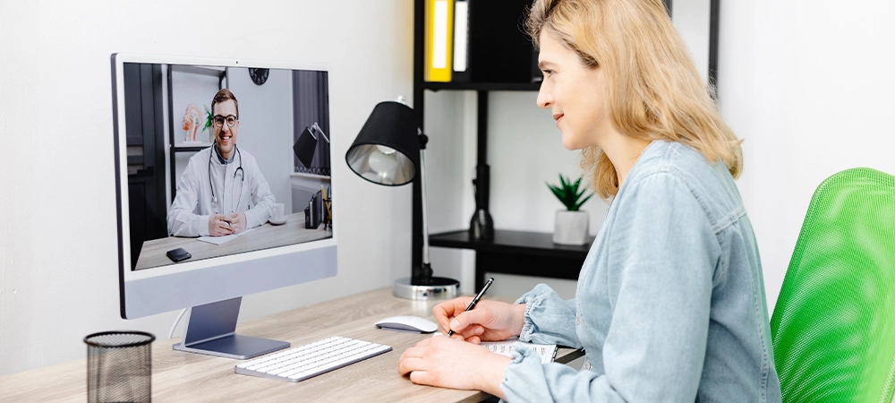 Caucasian doctor video conference call online live talk follow up remotely in medical result with woman sitting at chair at home. Online health care digital service concept