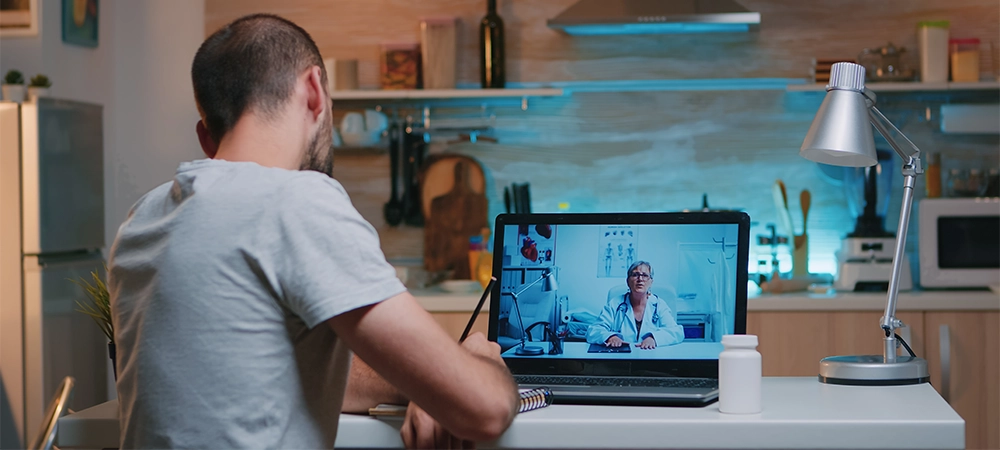 Man Consults with Doctor During Virtual Appointment