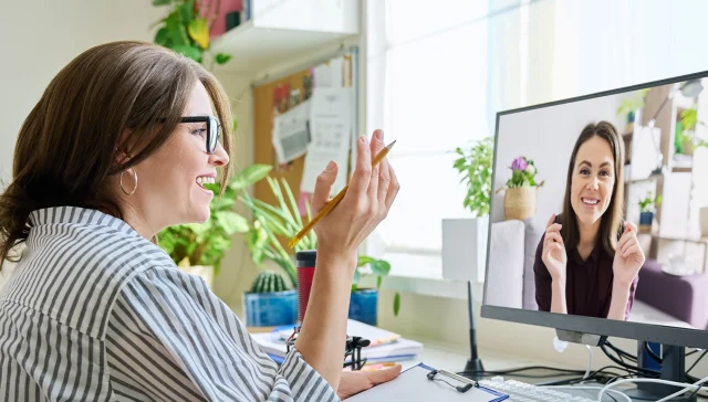 Mature woman talking online with young female using video call