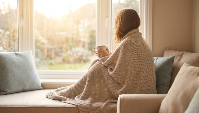 Person in early cocaine withdrawal recovery resting calmly by a window in Ontario